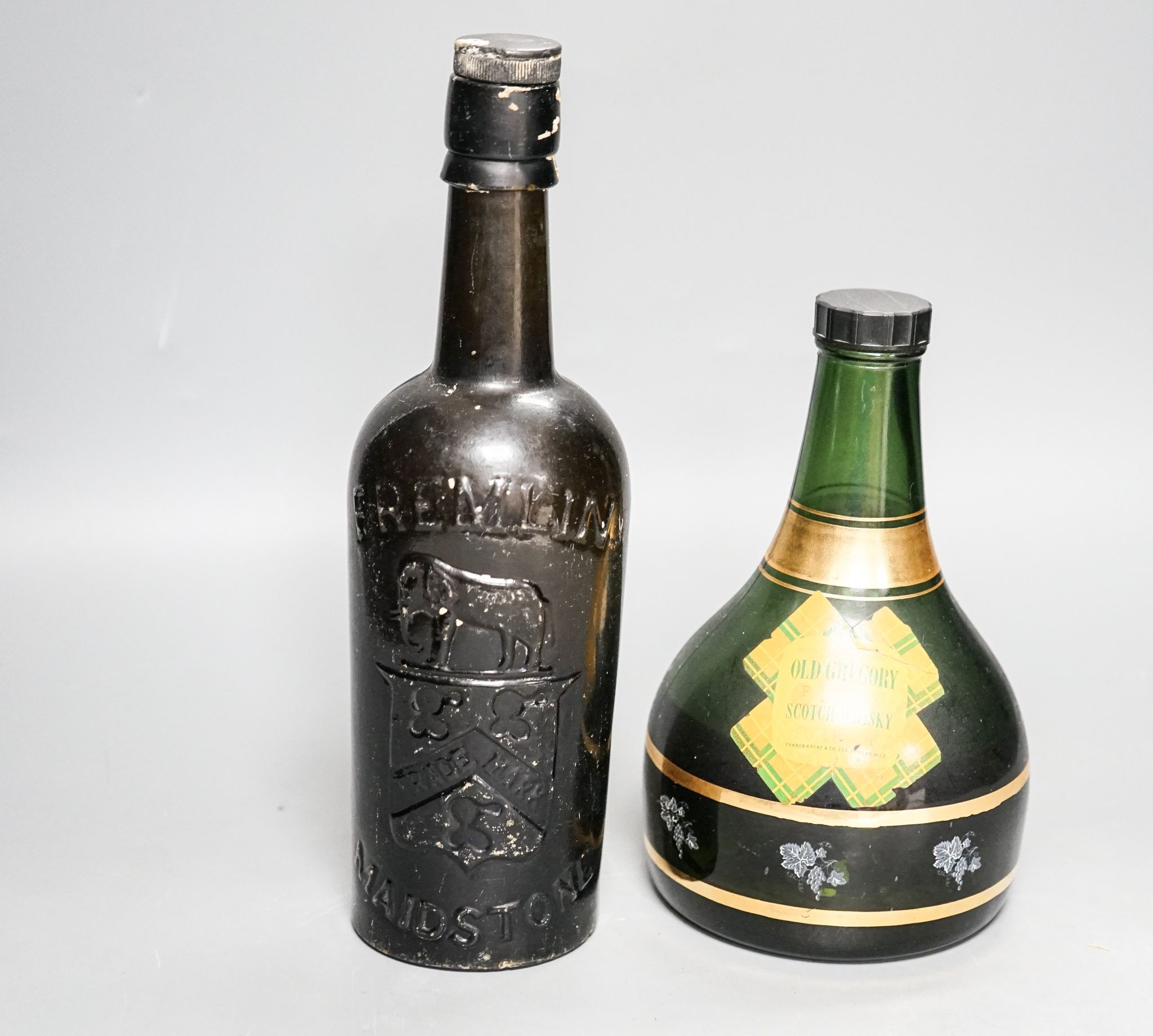 An old Fremlin of Maidstone beer bottle and an old Gregory Scotch whisky musical bottle